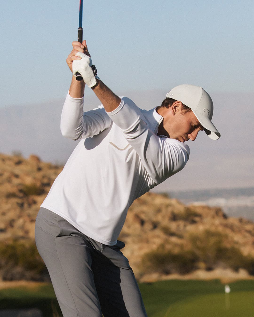 Tennis player Casper Ruud playing golf while wearing the off-court cap from Varsity Headwear