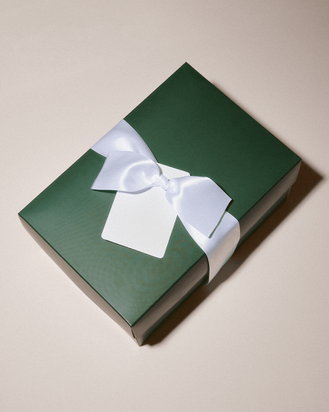 Front view of Varsity headwear giftwrapping with green box and white ribbon