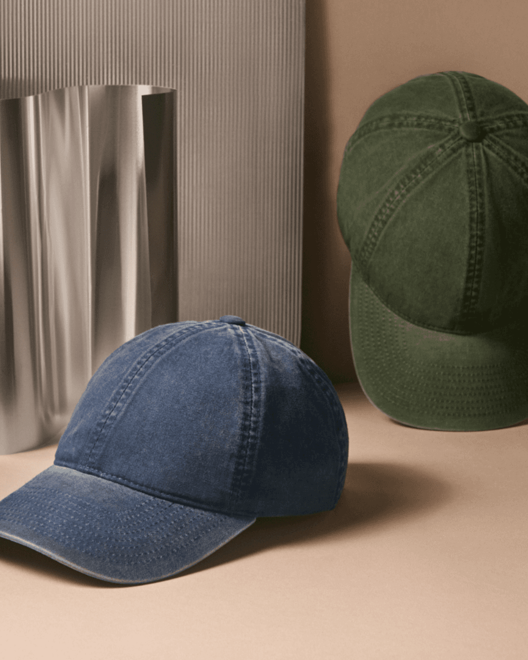 Front view studio image of washed cotton caps in green and navy