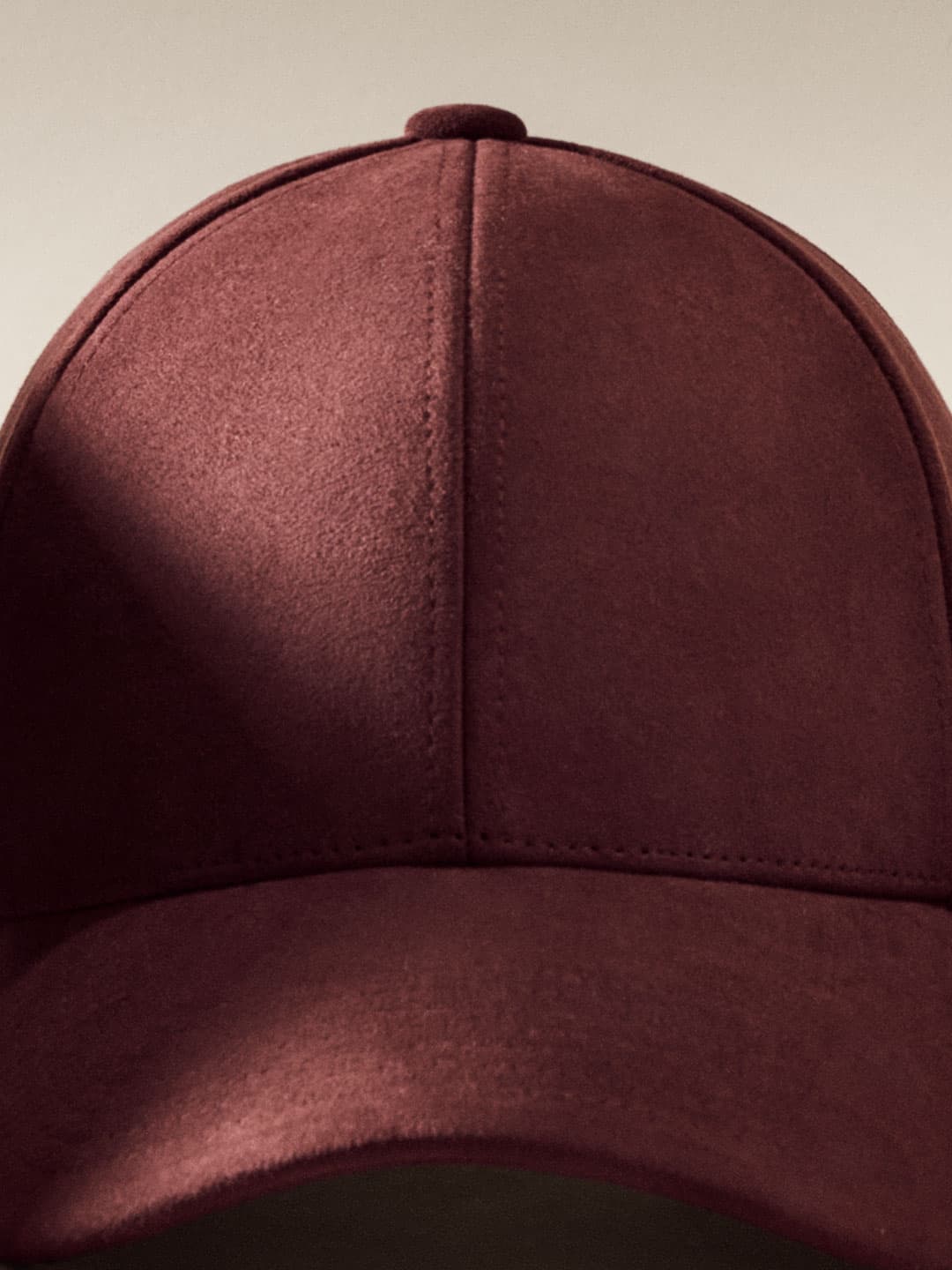 Close front view of burgundy alcantara cap from Varsity Headwear autumn winter 25 collection