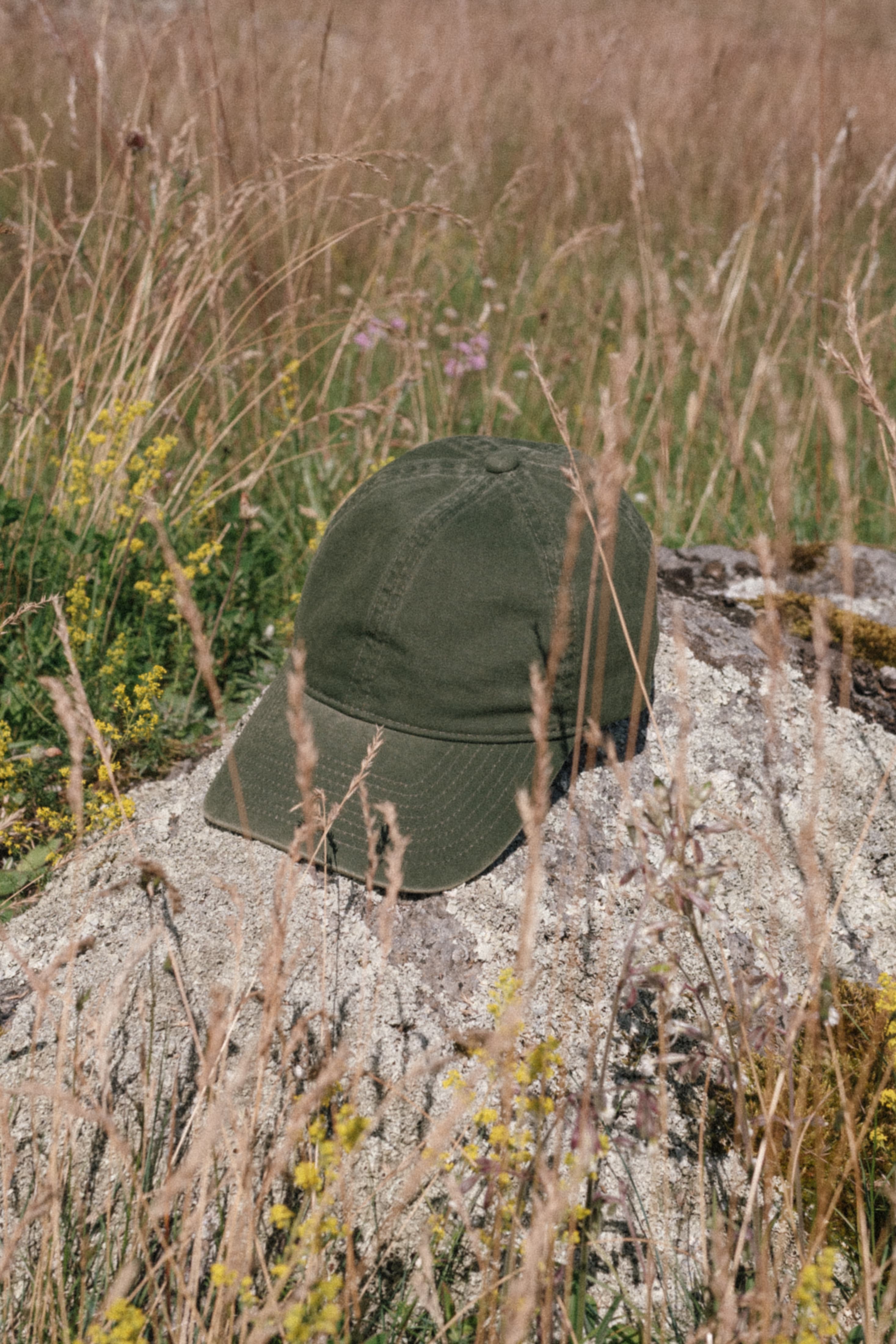 Green washed cotton cap in Norwegian summer landscape