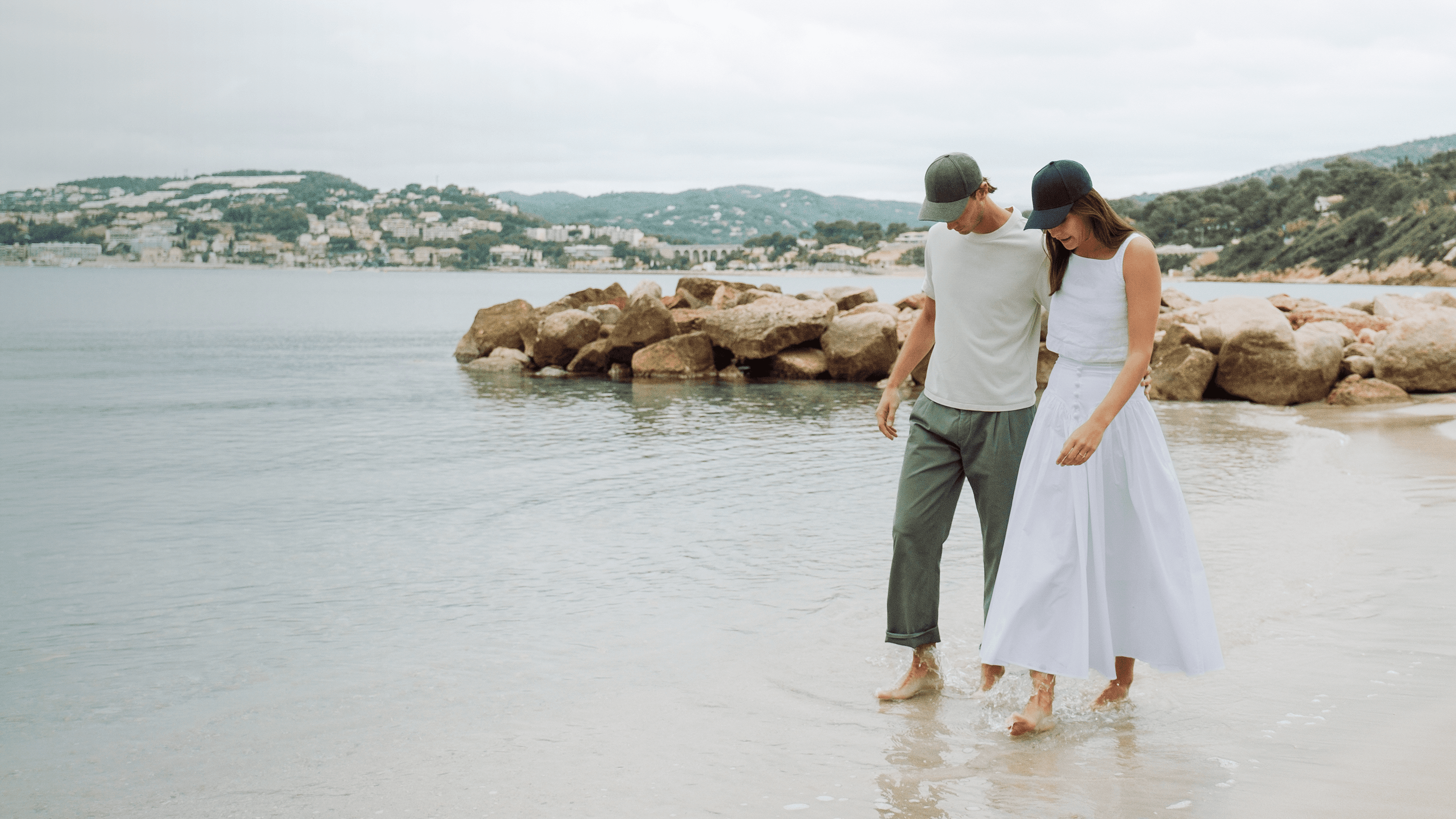 Front view of female and male model wearing green and dark navy linen cap