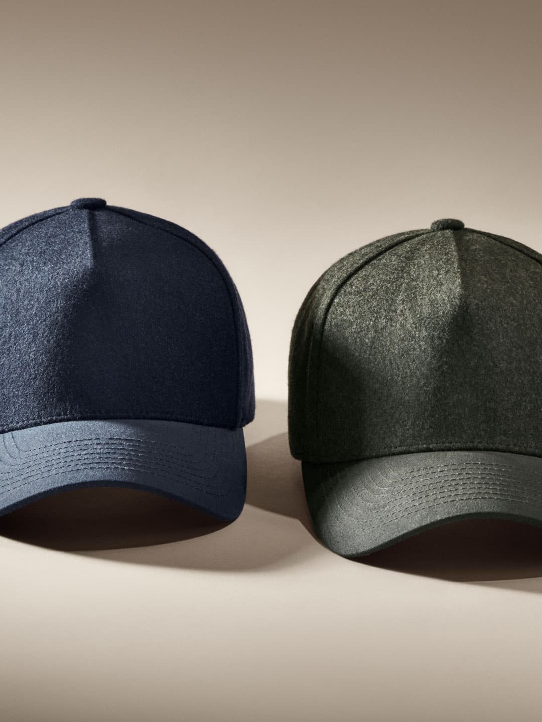 Front view of dark navy and ivy green cruz structured wool caps from Varsity Headwear
